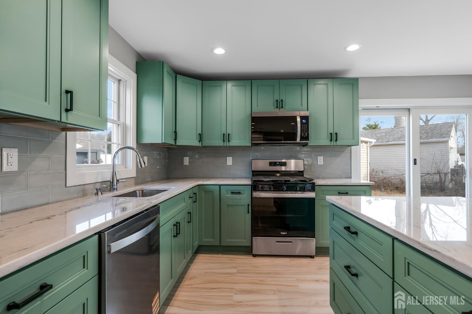 20 Louis Avenue Middlesex, NJ 08846 - Photo 7 of 22 a kitchen with stainless steel appliances granite countertop a sink stove and cabinets