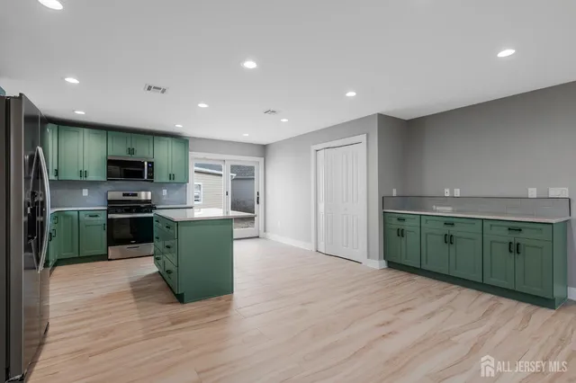 a kitchen with a refrigerator and a sink