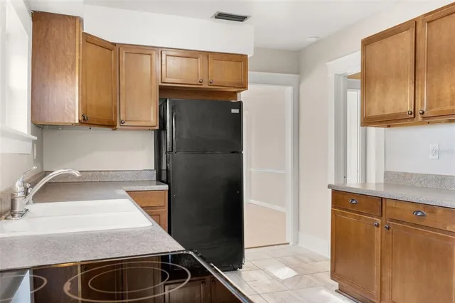 a kitchen with a sink stove and refrigerator