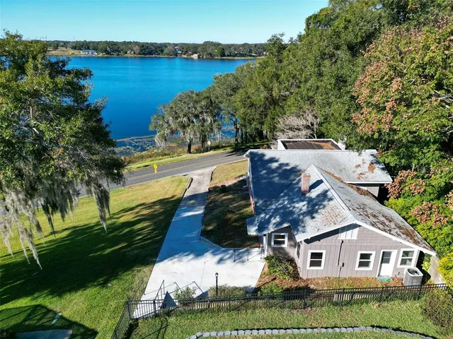 an aerial view of house with yard and swimming pool