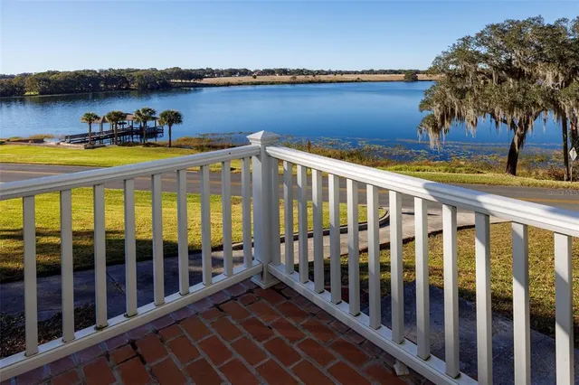 a view of a balcony with chair and wooden floor