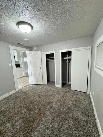 a large kitchen with kitchen island a sink a stove a oven a counter space and cabinets
