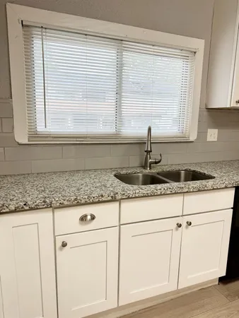 a stove top oven sitting inside of a kitchen