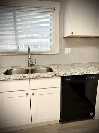 a stove top oven sitting inside of a kitchen