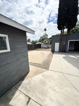 a backyard of a house with table and chairs