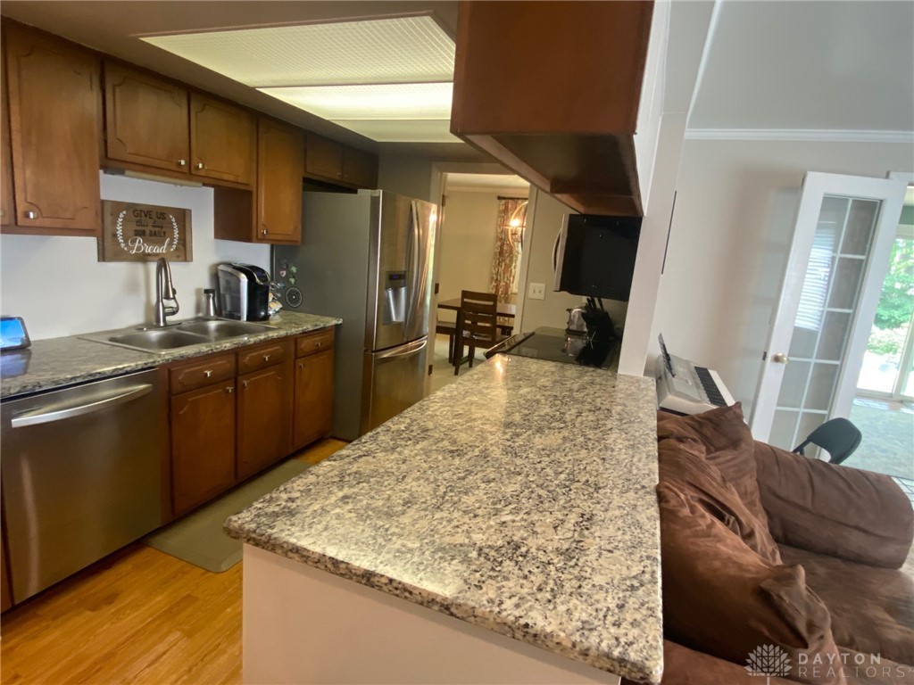 5768 Overbrooke Road Kettering, OH 45440 - Photo 9 of 27 Kitchen with granite countertops open to dining area - this galley kitchen is the hub!