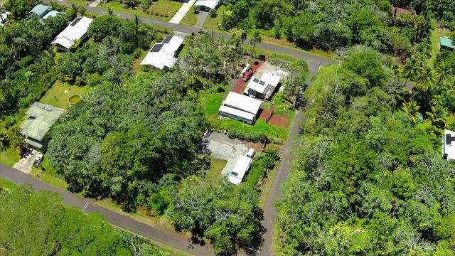 an aerial view of a house with a yard and outdoor seating