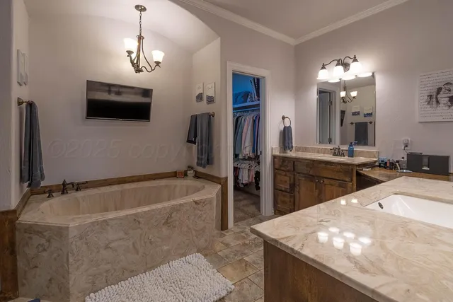 a bathroom with a tub sink and mirror