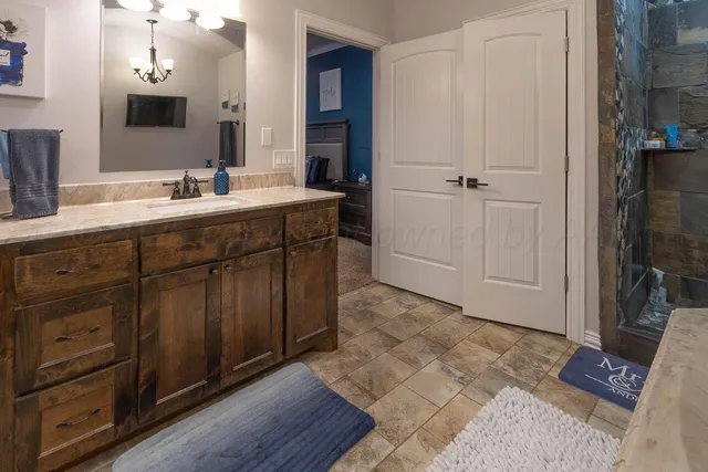 a spacious bathroom with a double vanity sink and a mirror