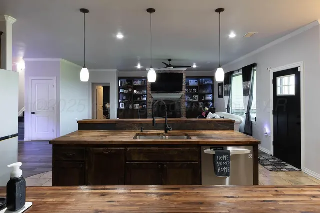 a kitchen with a stove and a wooden floor