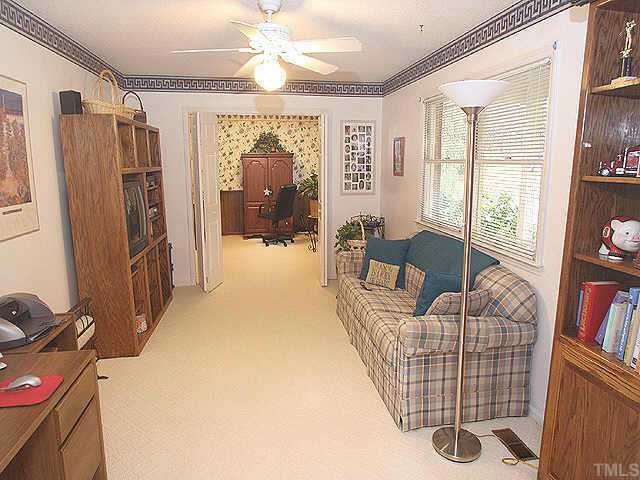 5015 Raintree Road Durham, NC 27712 - Photo 2 of 10 a living room with furniture a flat screen tv and a large window