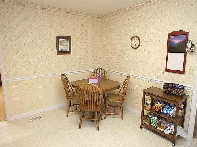 5015 Raintree Road Durham, NC 27712 - Photo 5 of 10 a view of a livingroom with furniture and a window