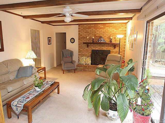 5015 Raintree Road Durham, NC 27712 - Photo 6 of 10 a living room with patio furniture and a floor to ceiling window