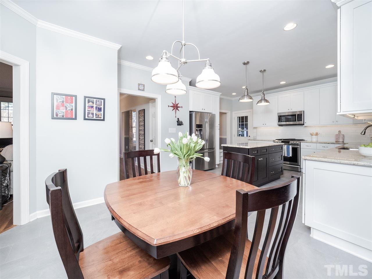 1003 Beringer Place Apex, NC 27502 - Photo 13 of 30 a view of a dining room with furniture and a chandelier