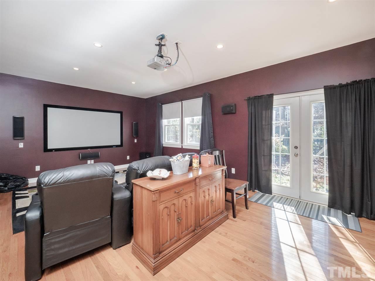 1003 Beringer Place Apex, NC 27502 - Photo 16 of 30 a living room with furniture a flat screen tv and floor to ceiling window