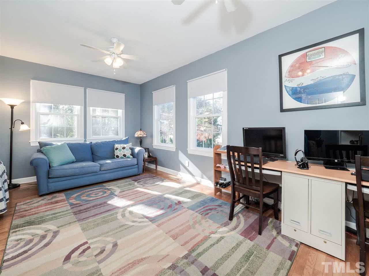 1003 Beringer Place Apex, NC 27502 - Photo 17 of 30 a living room with furniture a flat screen tv and a large window