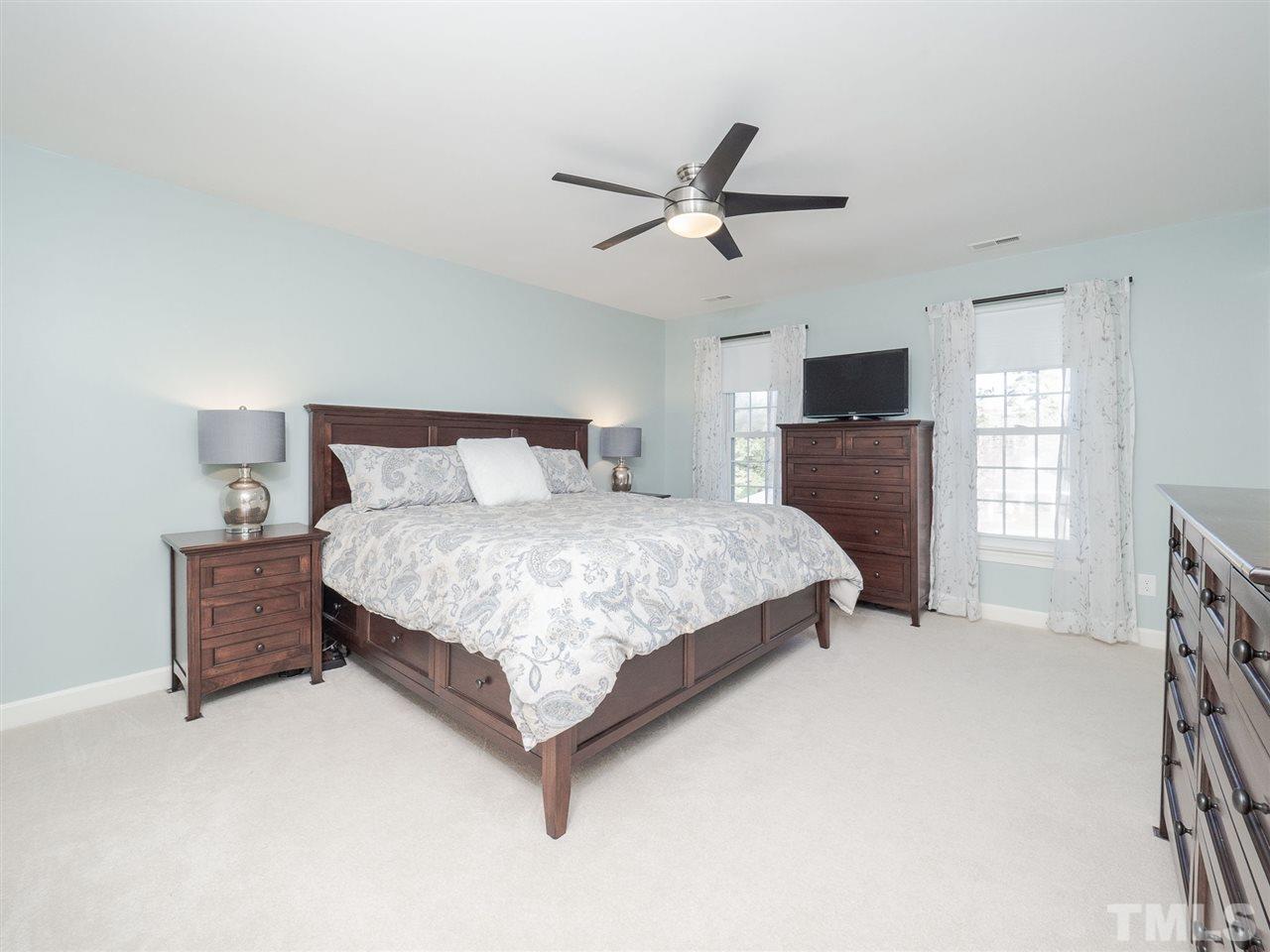 1003 Beringer Place Apex, NC 27502 - Photo 19 of 30 a bedroom with a bed and window