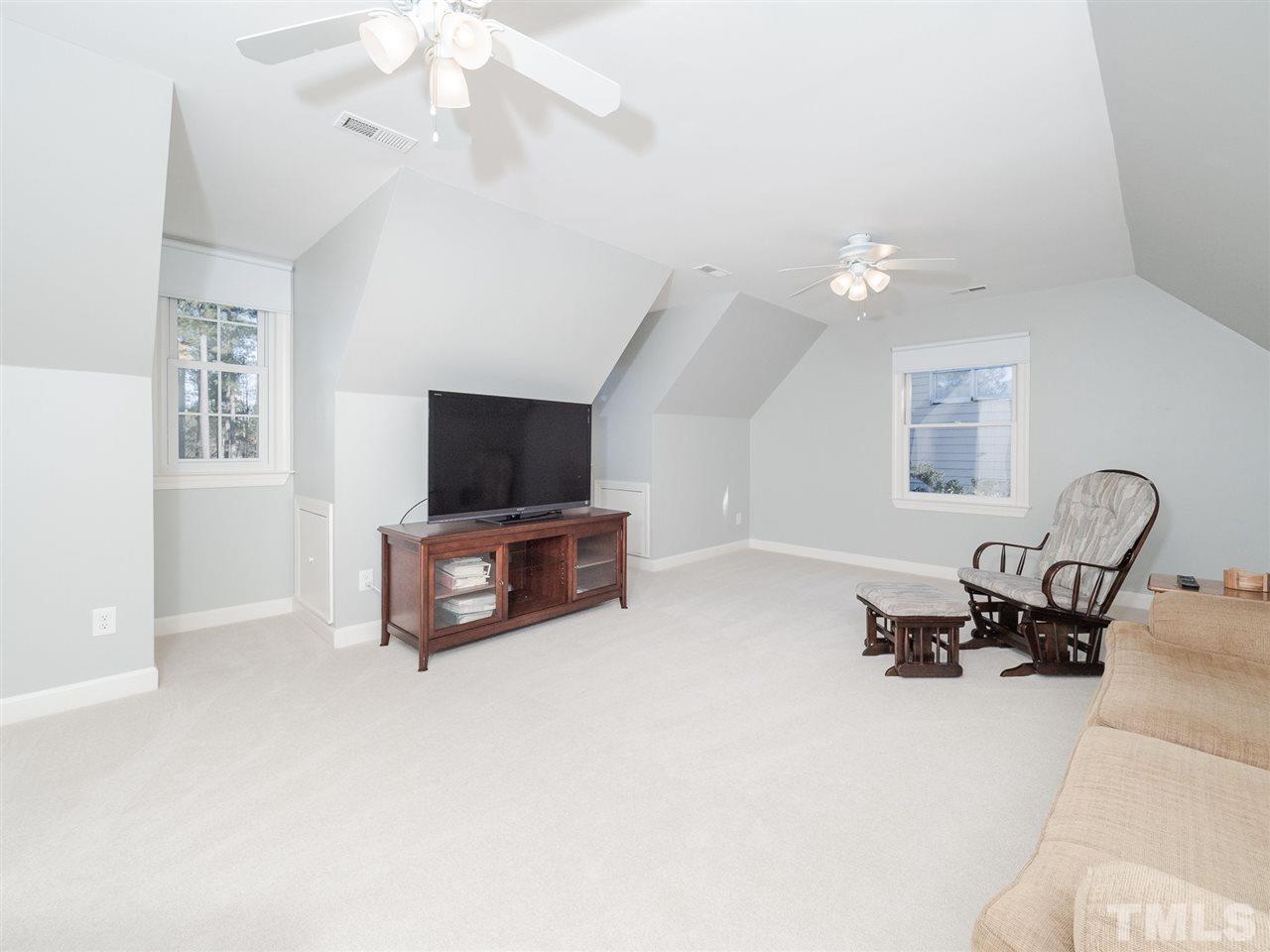1003 Beringer Place Apex, NC 27502 - Photo 25 of 30 a living room with furniture and a flat screen tv