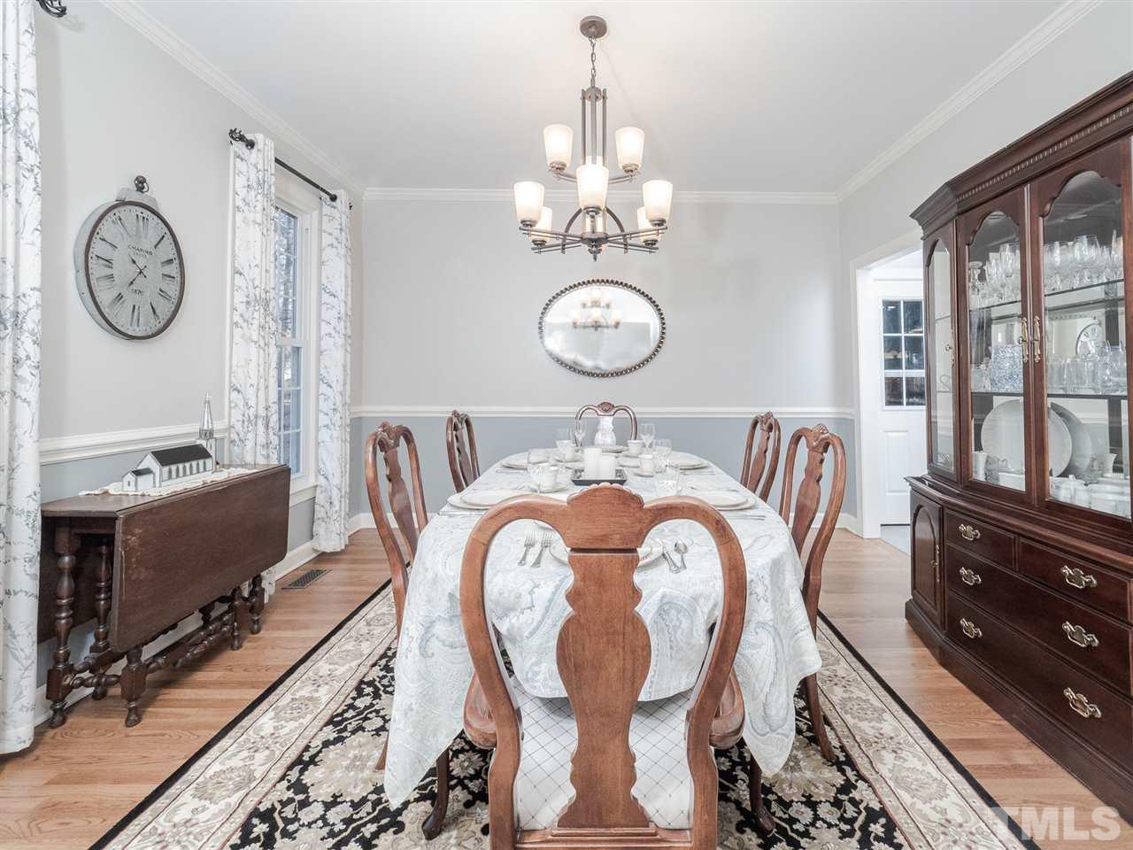 1003 Beringer Place Apex, NC 27502 - Photo 5 of 30 a view of a dining area with furniture window and wooden floor