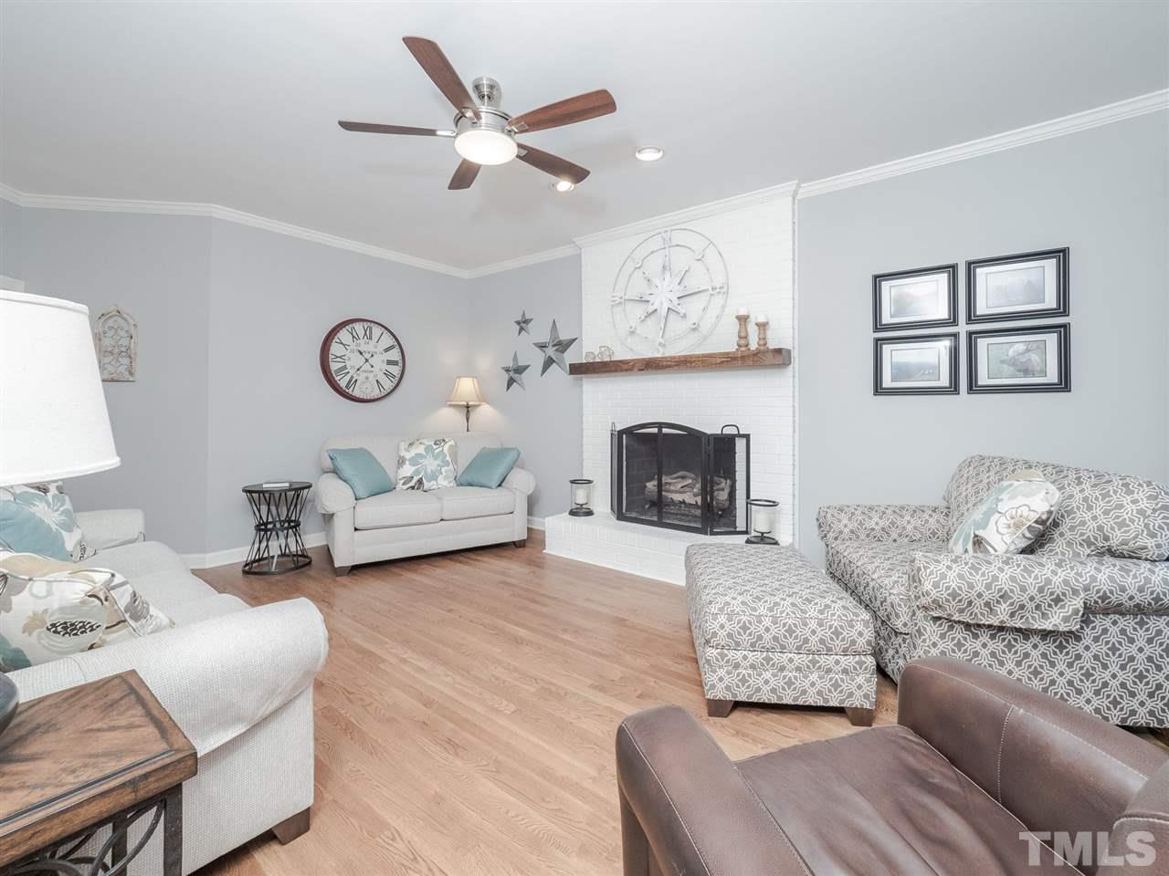 1003 Beringer Place Apex, NC 27502 - Photo 6 of 30 a living room with furniture and a fireplace