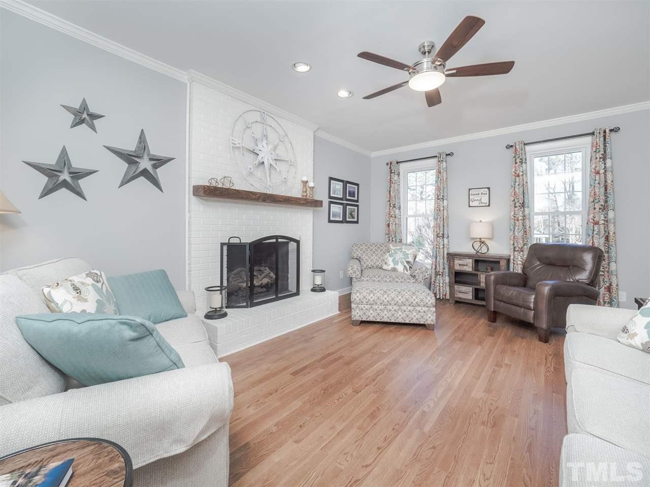 1003 Beringer Place Apex, NC 27502 - Photo 7 of 30 a living room with furniture and a fireplace