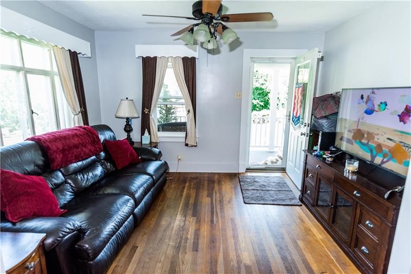 1599 Pine Run Road Rochester, PA 15074 - Photo 11 of 13 Hardwood floors extend from dining area into the living area.