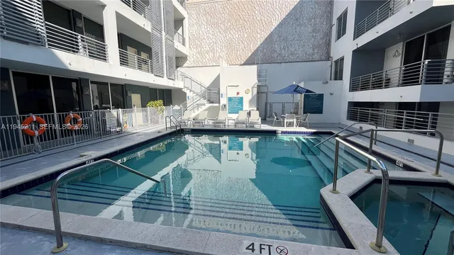 a swimming pool view with a outdoor seating