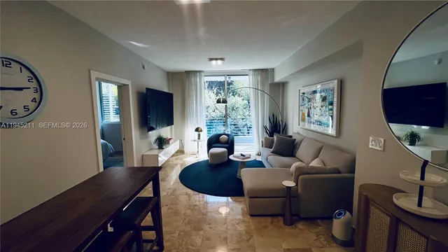 a living room with furniture a large window and a flat screen tv