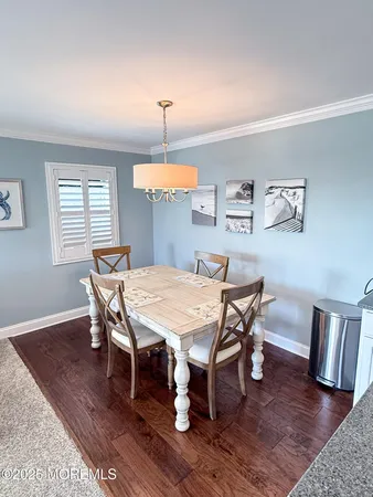 a view of a dining room with furniture wooden floor and chandelier