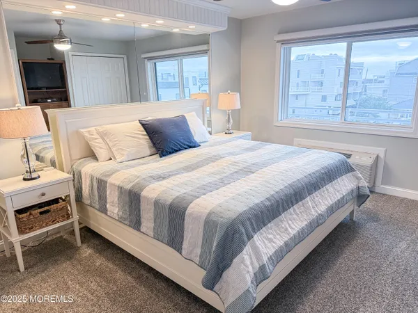 a bedroom with a bed and a night stand