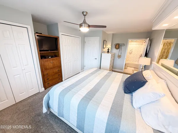 a bedroom with a bed and a television