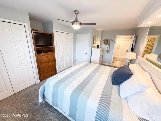 a bedroom with a bed and a television