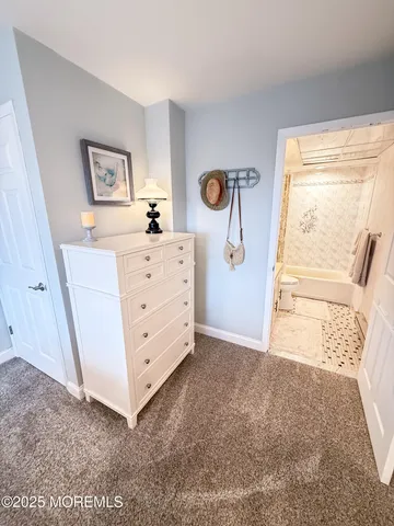 a view of a bedroom with baby crib and hallway