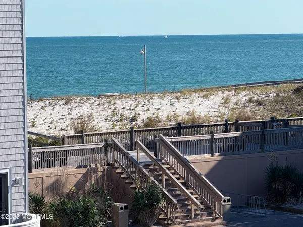 a view of roof deck with wooden floor and seating space
