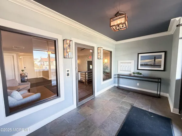 a view of a hallway with bathroom and glass door