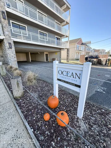 a view of a big house with a big yard and large tree