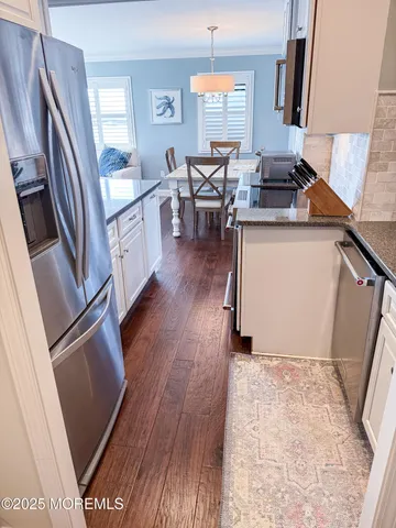 a kitchen with sink refrigerator and window