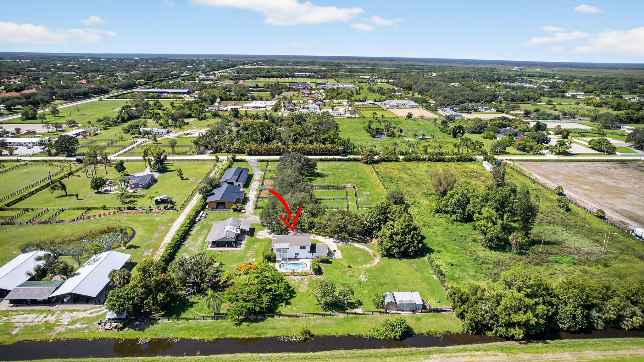 16229 Rustic Road Wellington, FL 33470 - Photo 113 of 140 an aerial view of residential houses with outdoor space and swimming pool