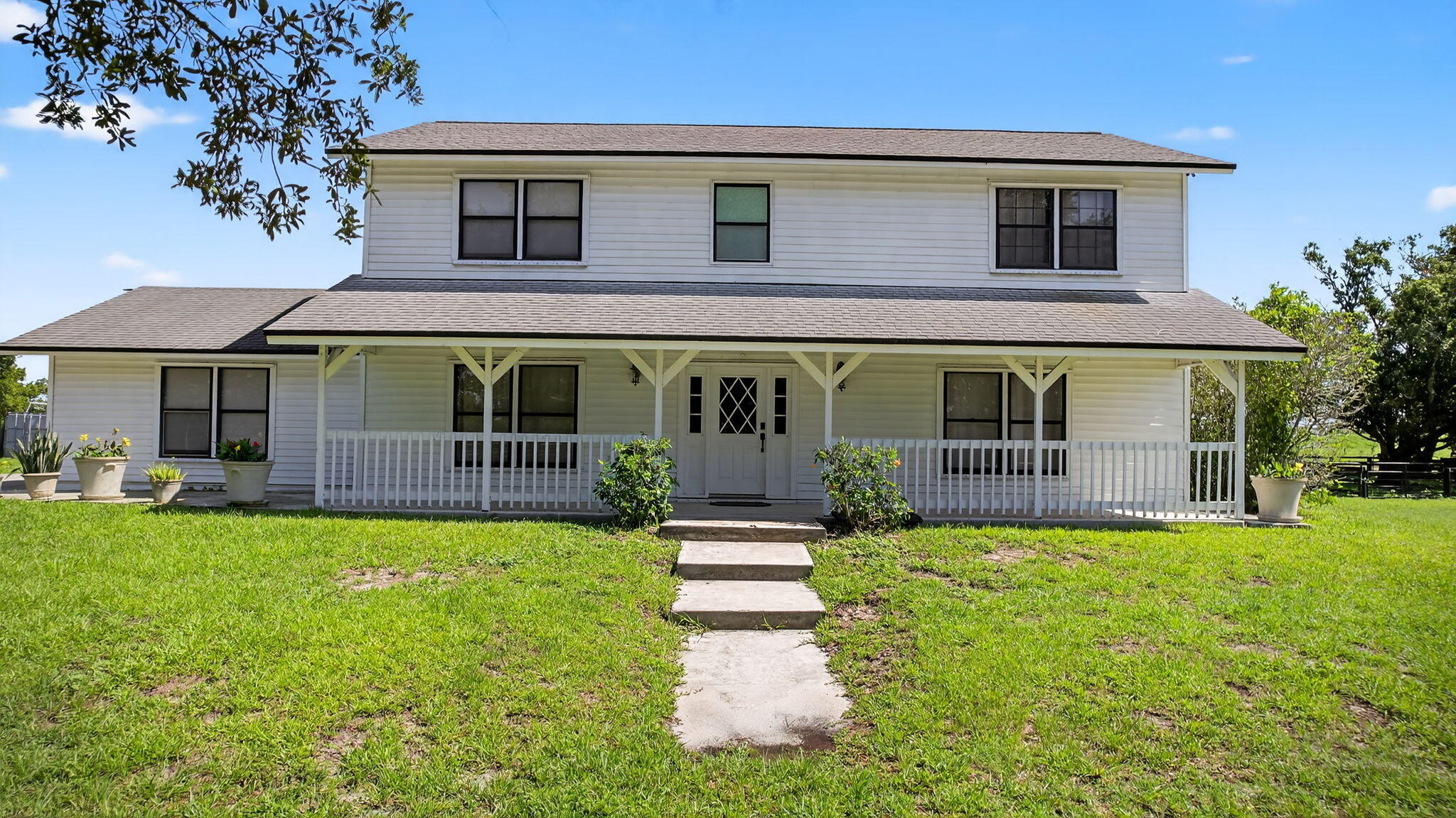 16229 Rustic Road Wellington, FL 33470 - Photo 126 of 140 a front view of a house with a yard