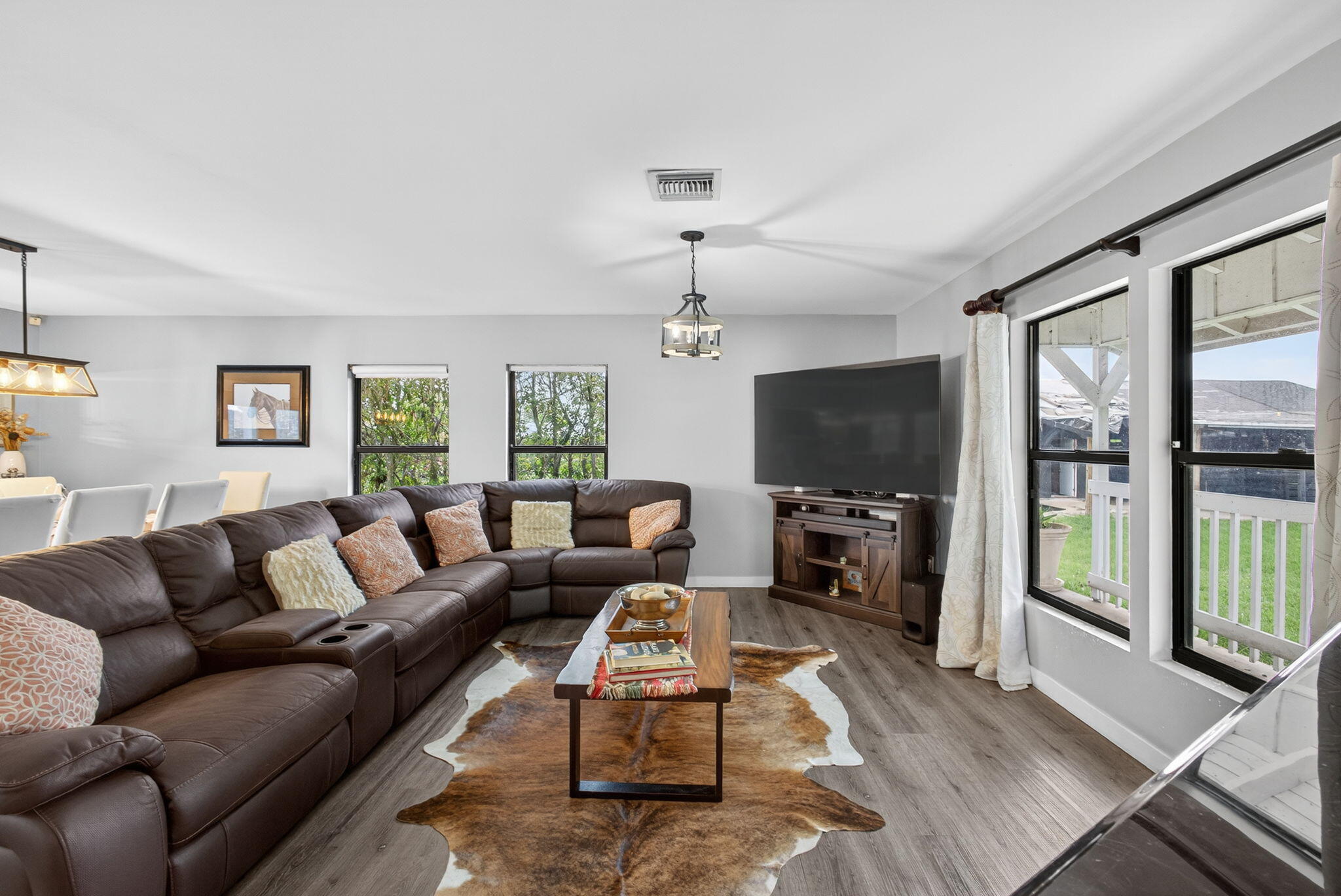 16229 Rustic Road Wellington, FL 33470 - Photo 18 of 140 a living room with furniture flat screen tv and a large window