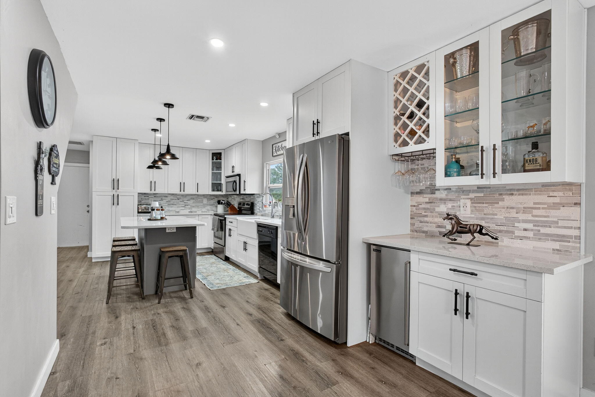 16229 Rustic Road Wellington, FL 33470 - Photo 25 of 140 a kitchen with stainless steel appliances a refrigerator sink and wooden floor