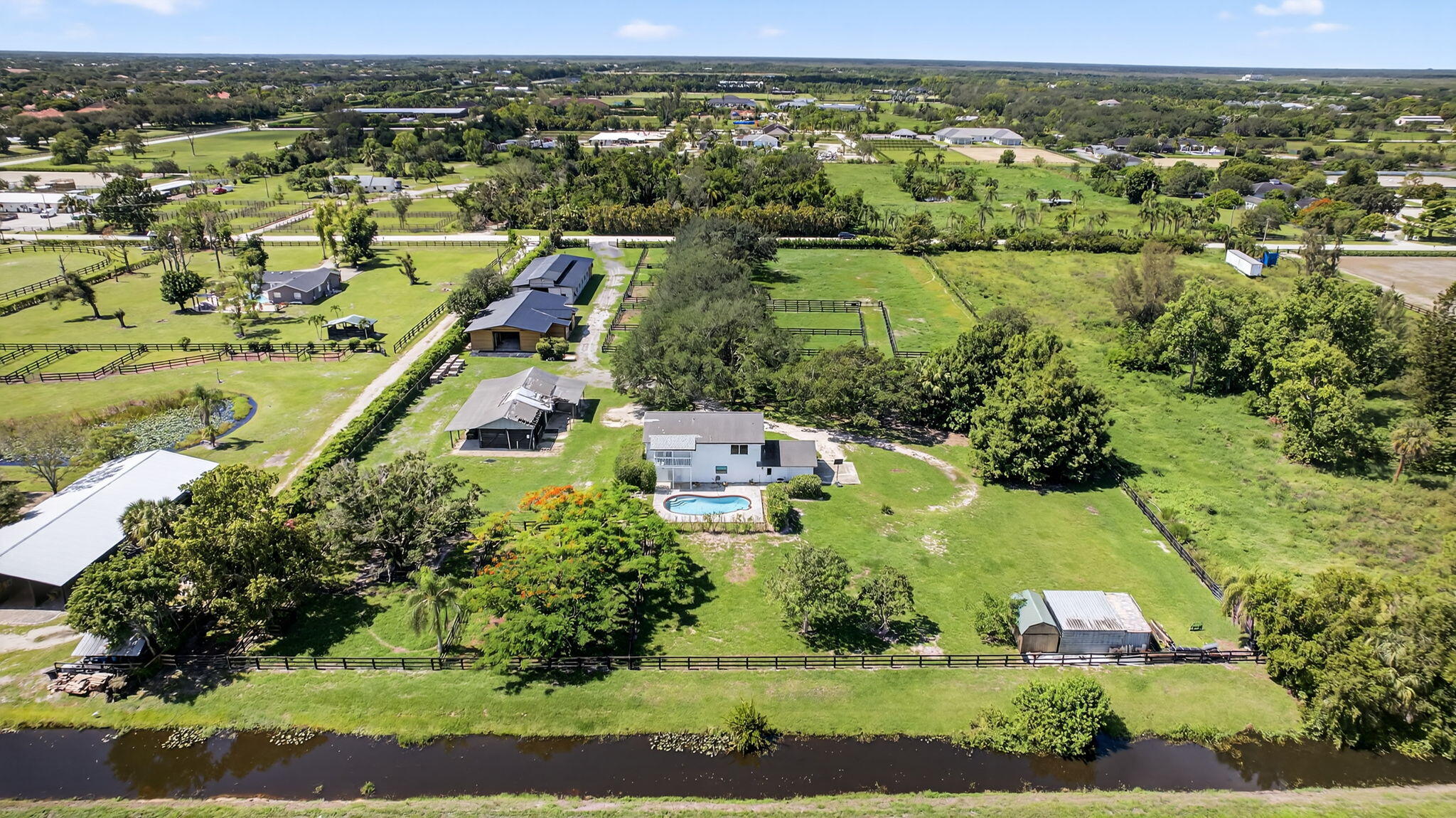 16229 Rustic Road Wellington, FL 33470 - Photo 4 of 140 an aerial view of residential houses with outdoor space and lake view