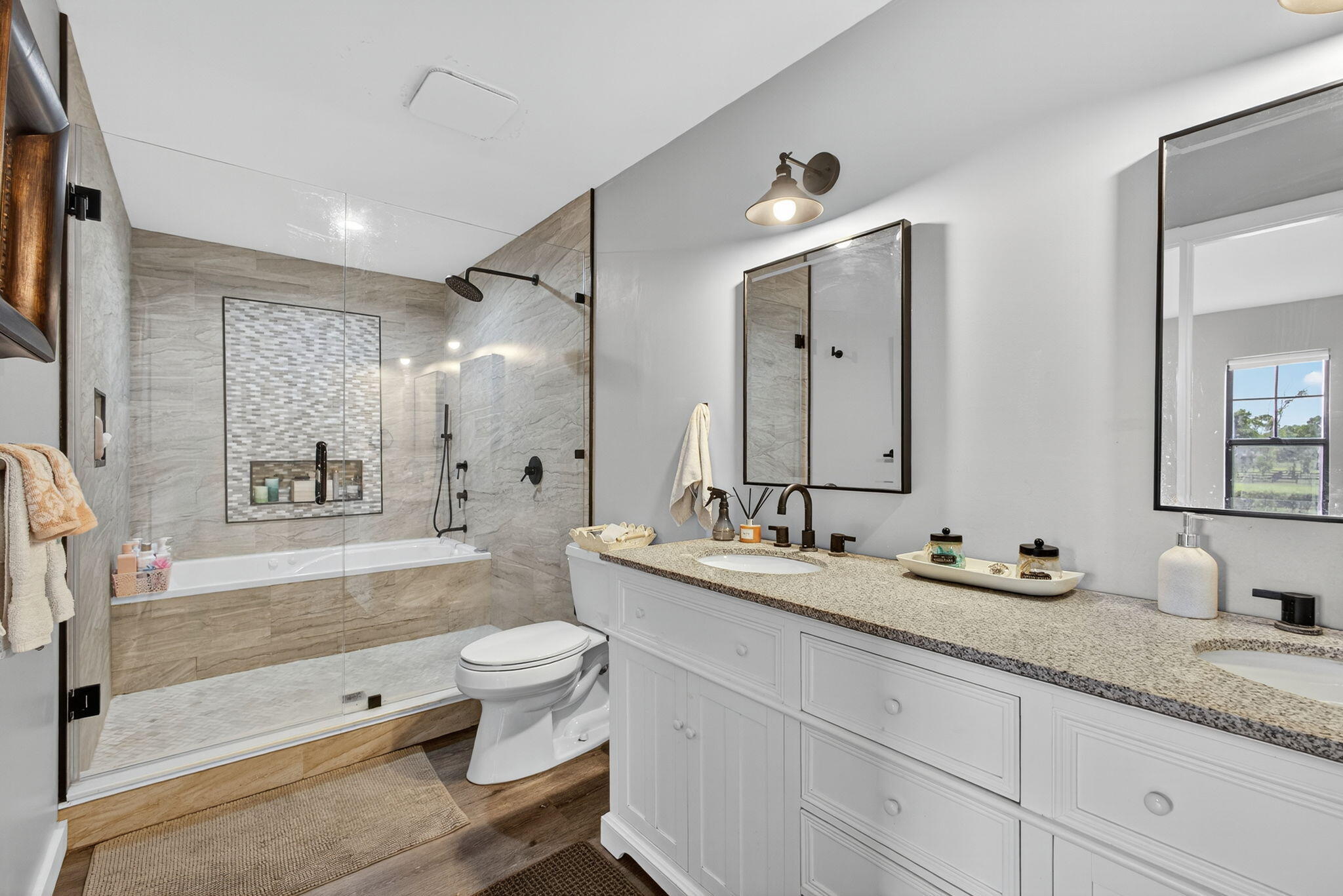 16229 Rustic Road Wellington, FL 33470 - Photo 48 of 140 a bathroom with a double vanity sink toilet mirror and bathtub