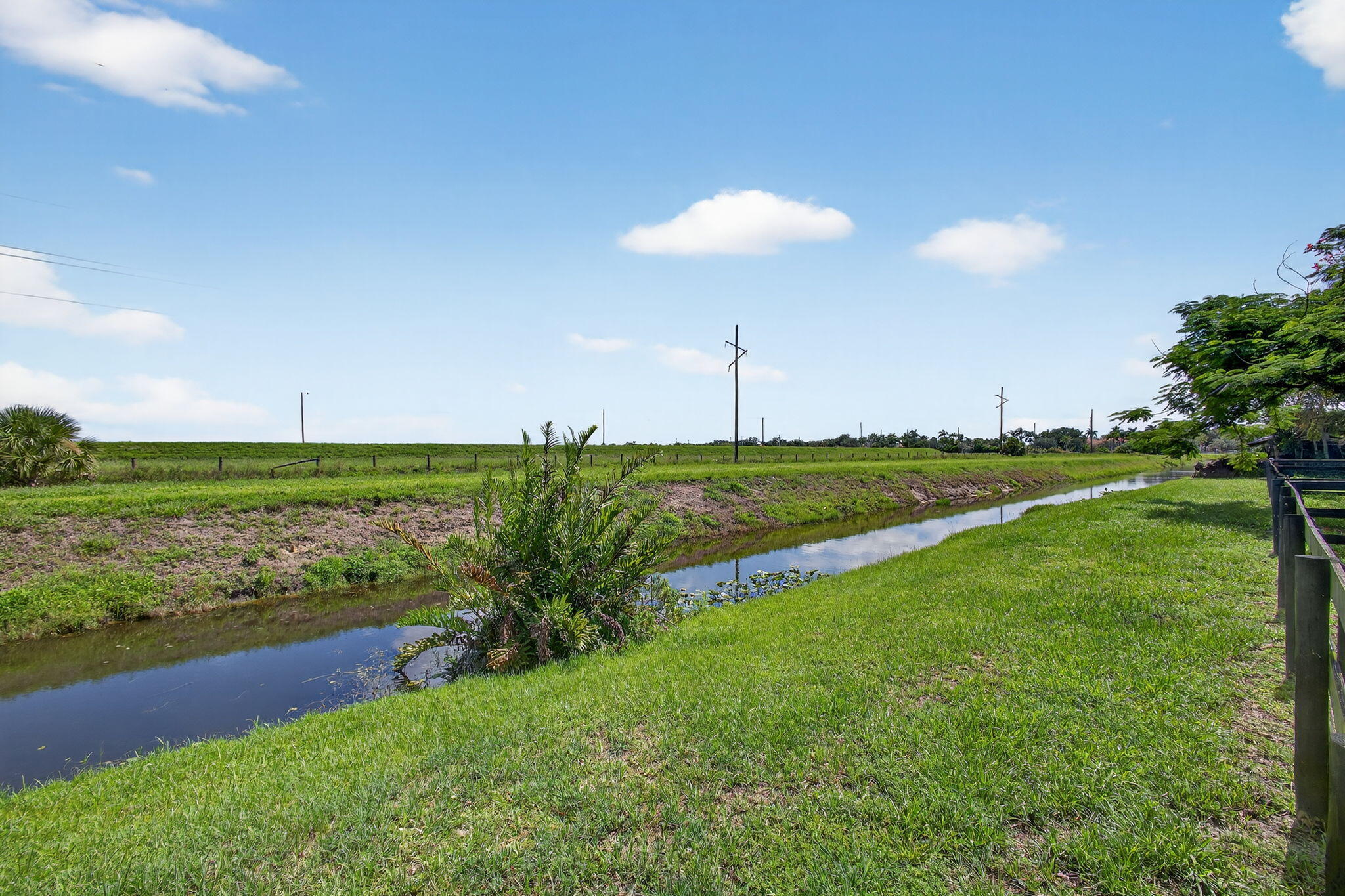 16229 Rustic Road Wellington, FL 33470 - Photo 62 of 140 a view of a golf course with a lake