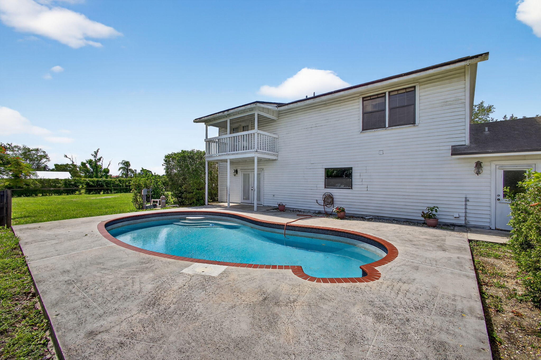 16229 Rustic Road Wellington, FL 33470 - Photo 66 of 140 a view of a house with swimming pool and yard
