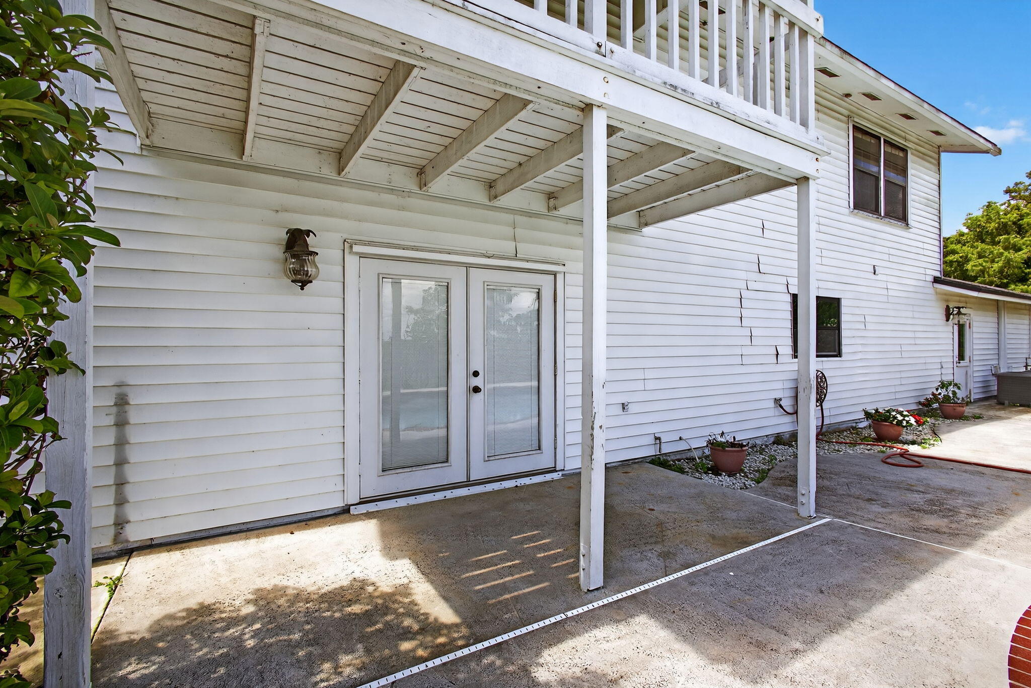 16229 Rustic Road Wellington, FL 33470 - Photo 69 of 140 a view of a porch with a table and chairs and potted plants