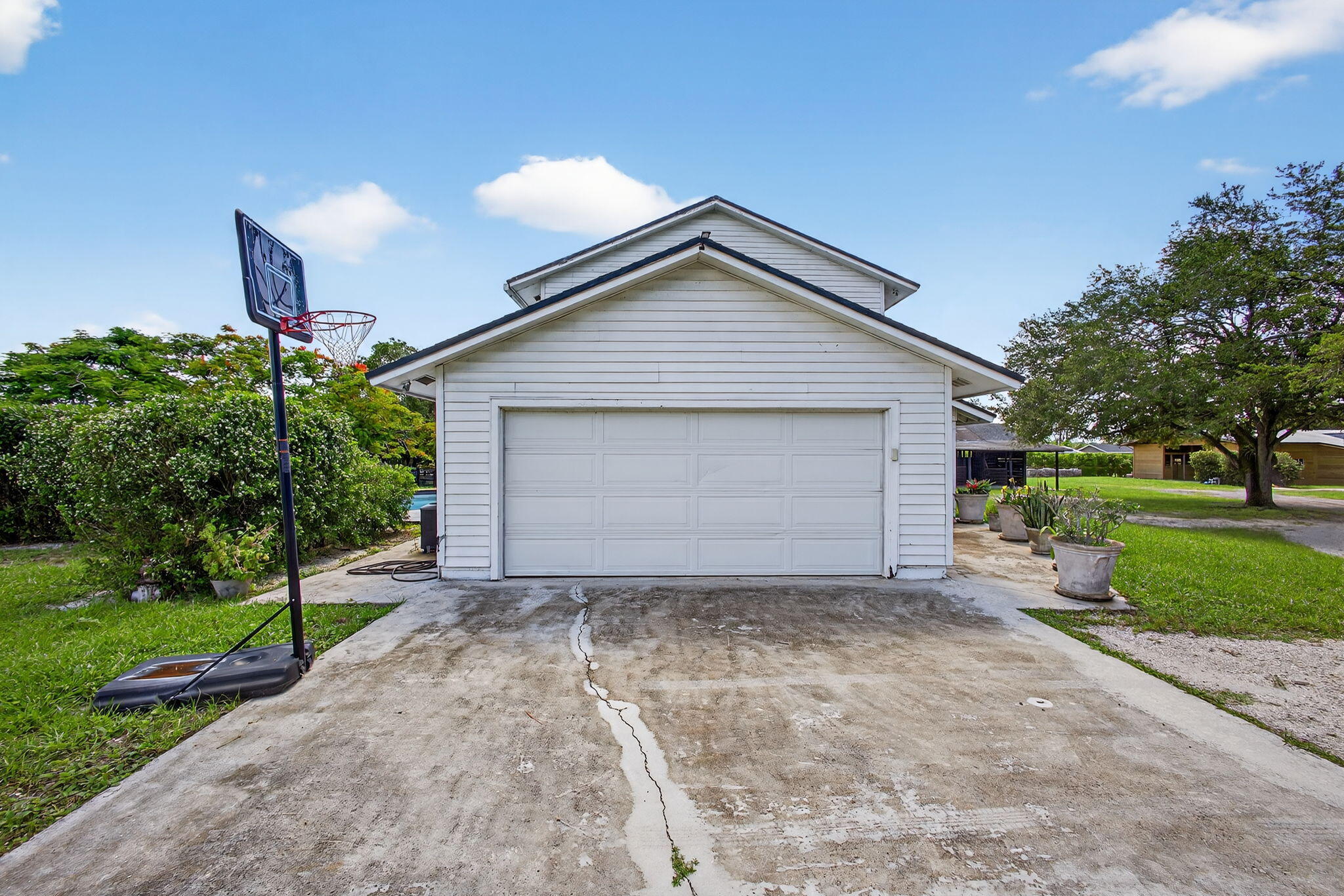 16229 Rustic Road Wellington, FL 33470 - Photo 74 of 140 a front view of a house with a yard and garage