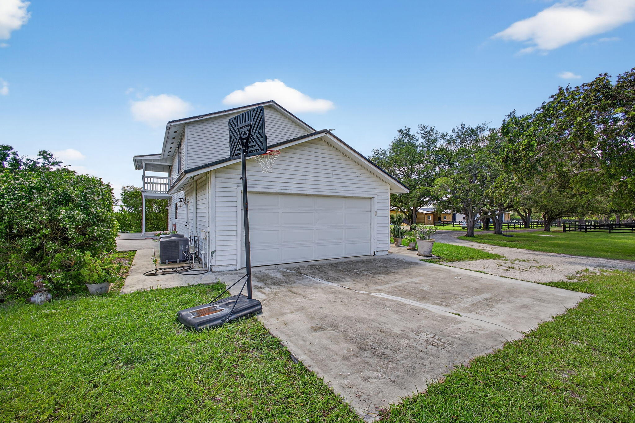 16229 Rustic Road Wellington, FL 33470 - Photo 75 of 140 a view of a house with a yard and large tree