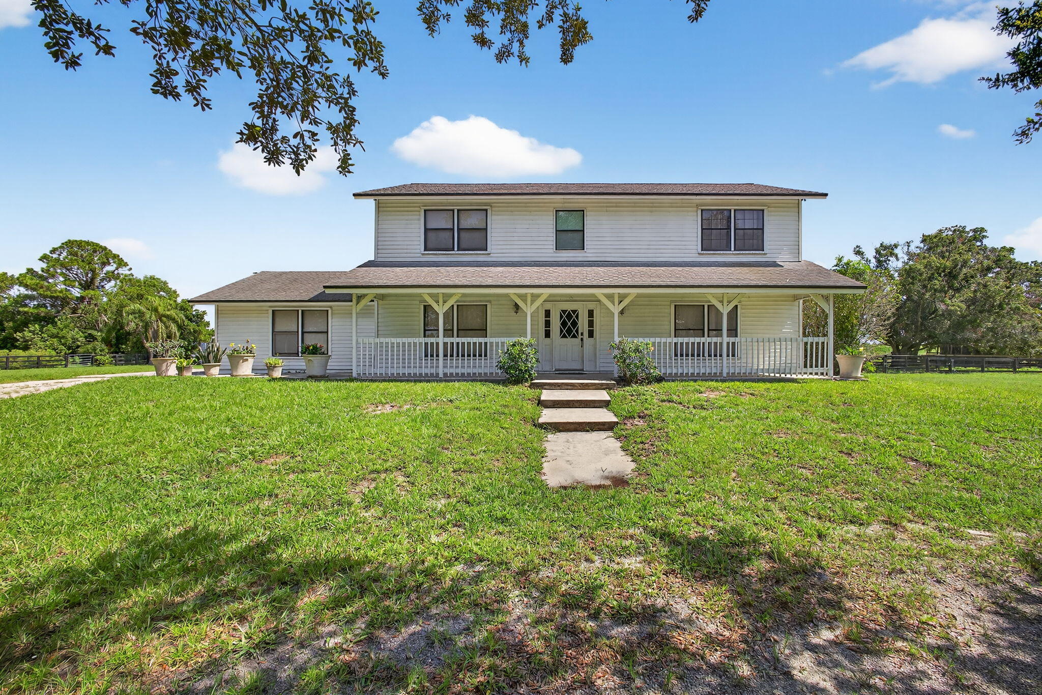 16229 Rustic Road Wellington, FL 33470 - Photo 8 of 140 a front view of a house with garden