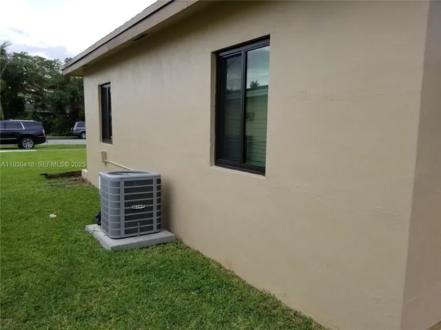 a backyard of a house with barbeque oven
